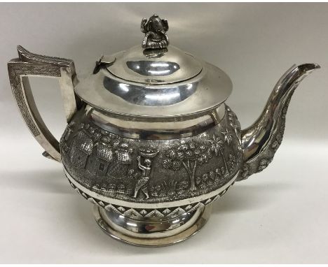 A heavy Indian silver teapot, the body attractively decorated with figures. Approx. 615 grams. Est. £300 - £400.