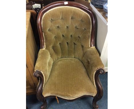 A button back scroll decorated armchair.