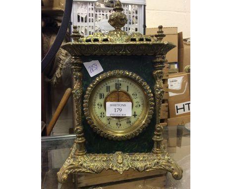 A brass mounted mantle clock.