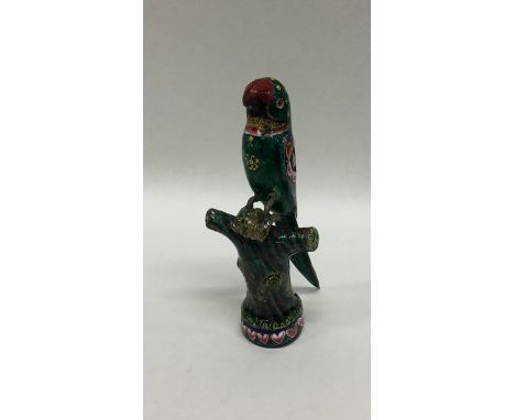 A novelty enamelled model of a parrot on perch. Approx. 45 grams. Est. £50 - £80.