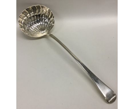 A heavy silver OE ladle with shell bowl. Approx. 252 grams. Est. £150 - £200.
