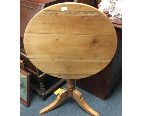 A pine tripod table.