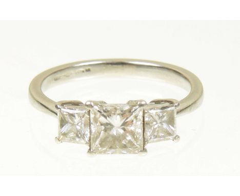 A platinum diamond three stone ringThe square shaped diamond with similarly shaped diamond sides, hallmarks for Birmingham, e