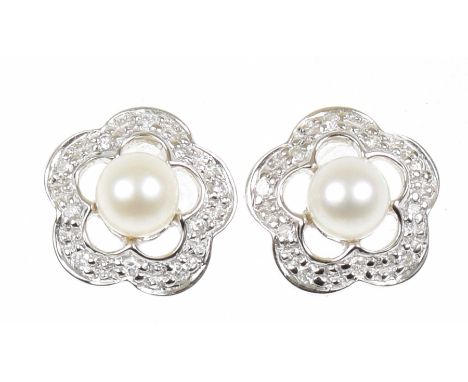 A pair of 18ct gold cultured pearl and diamond earringsOf floral design, the cultured pearls within a brilliant cut diamond s