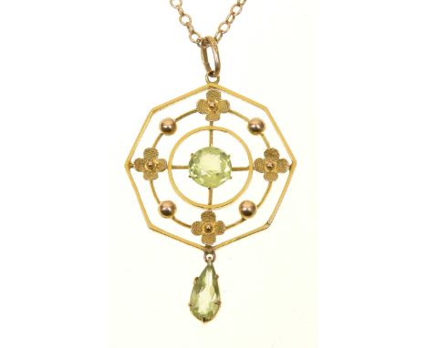 An early 20th Century peridot pendantThe circular shaped peridot within an openwork octagonal surround, with polished sphere 