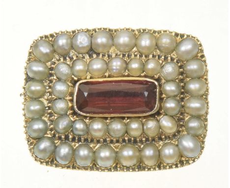 A Georgian memorial broochThe rectangular red paste within a split pearl tiered surround and bearing personal inscription to 
