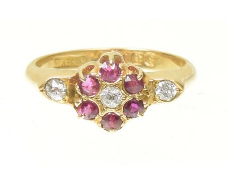 An Edwardian 18ct gold ruby and diamond cluster ringThe old cut diamond and circular shaped ruby floral cluster with old cut 