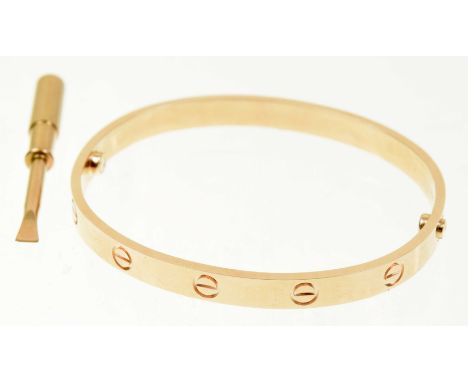 A Cartier 'Love' bangleDesigned as a series of screw head motifs with screw fitting, signed and numbered Cartier CRD307920, i