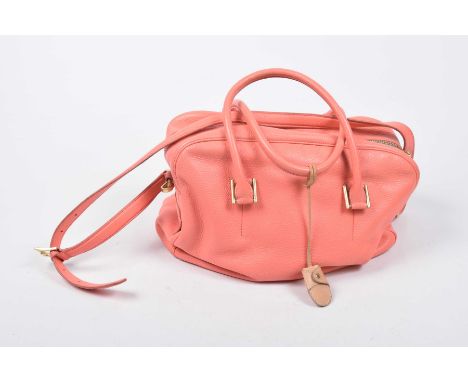 A Paul Smith handbagThe coral leather bag with twin handles, gold-tone hardware, Paul Smith logo and pale luggage tag, approx