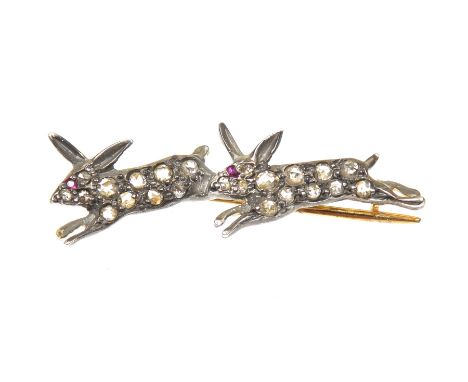 A diamond and ruby broochDesigned as a pair of rose cut diamond running rabbits, with circular shape ruby eyes, length 3.3cm,
