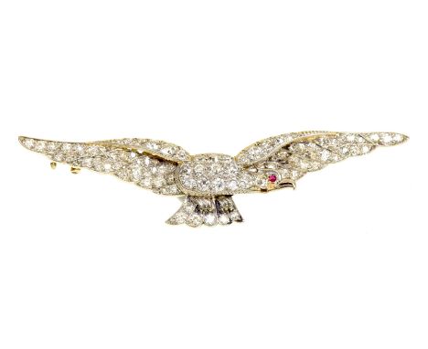 An early 20th century diamond broochIn the form of a flying eagle, with an old cut diamond body, wings, and a circular ruby c