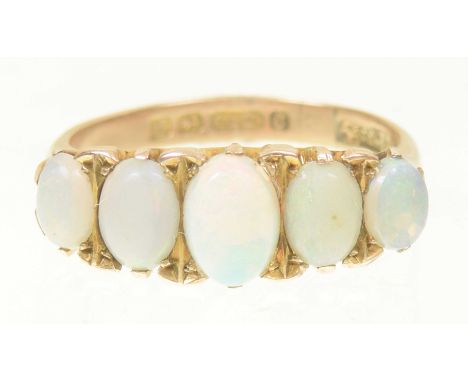 A 9ct gold opal five stone ringThe graduated oval opal cabochon line with tapered shoulders, hallmarks for Birmingham, 1939, 