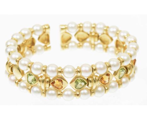 A peridot citrine and cultured pearl bangleOf sprung design, the series of heart shaped peridot and citrine collets with groo