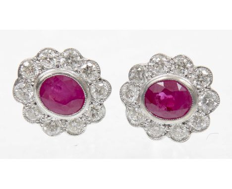 A pair of ruby and diamond cluster earringsEach designed as an oval shaped ruby within a brilliant cut diamond scalloped surr