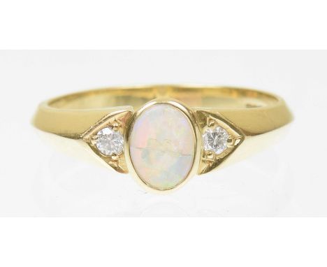 An 18ct gold opal and diamond dress ringThe oval shaped opal panel with brilliant cut diamond sides, AF, hallmarks for Birmin