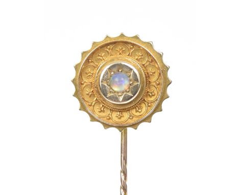 An early 20th Century opal stick pinThe circular opal cabochon within a star setting and circular cannetille surround, stampe