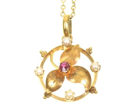 An early 20th Century ruby and split pearl pendantThe circular shaped ruby atop a leaf within an openwork split pearl surroun