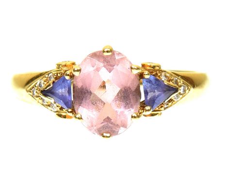 A tourmaline tanzanite and diamond dress ringThe oval shaped pink tourmaline with triangular shaped tanzanite sides and diamo
