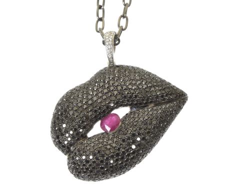An 18ct gold Gavello diamond and ruby pendantThe pavé set black diamond lips encasing an oval shaped ruby, to the similarly s
