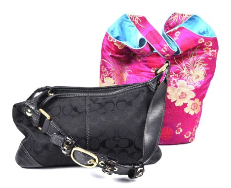A Coach monogram handbagThe monogrammed black canvas bag with black leather accents and single strap with gold-tone hardware 