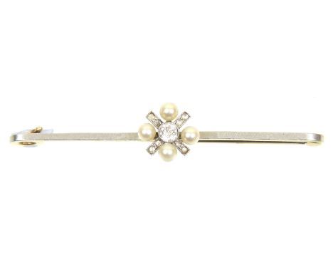 An early 20th Century diamond and seed pearl broochThe old cut diamond collet within a seed pearl quatrefoil surround atop th