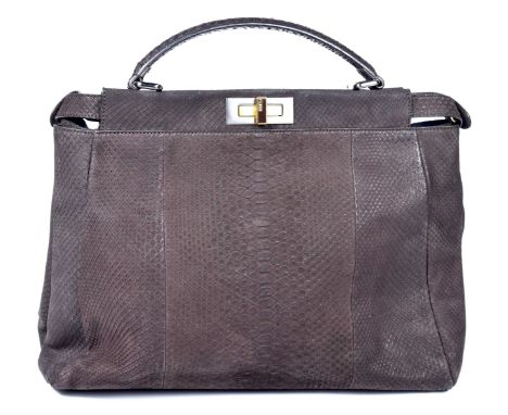 A Fendi Peekaboo handbag The structured brown exterior with rolled handle, gold and silver-tone hardware and brown enamel dua
