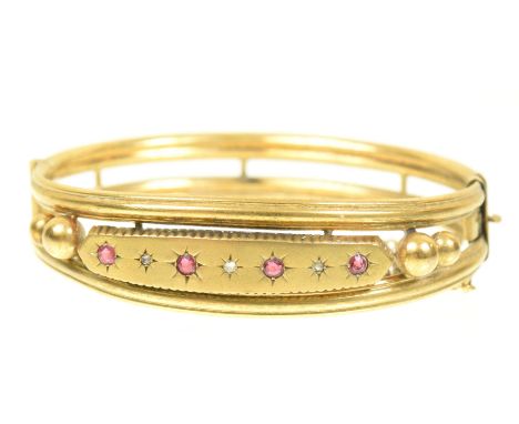 A late Victorian ruby and diamond bangleThe circular shape ruby and rose cut diamond line within star settings, and polished 