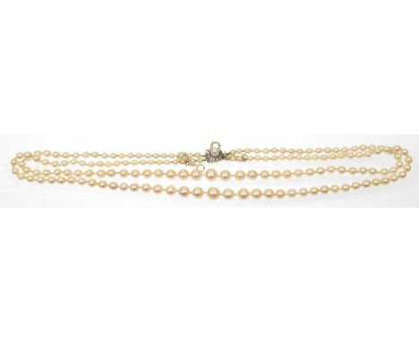 A cultured pearl and diamond necklaceThe double strand of graduated cultured pearls with an old cut diamond and cultured pear
