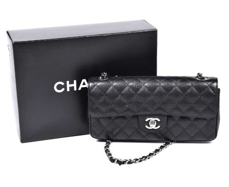 A Chanel New Mini Classic Flap HandbagThe quilted black caviar leather exterior with silver-tone hardware, single chain and i