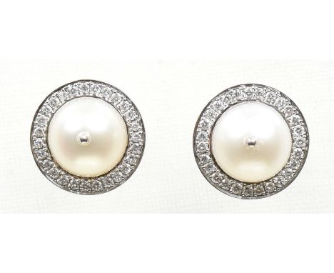 A pair of cultured pearl and diamond earringsEach designed as a cultured pearl, within a brilliant cut diamond halo surround,