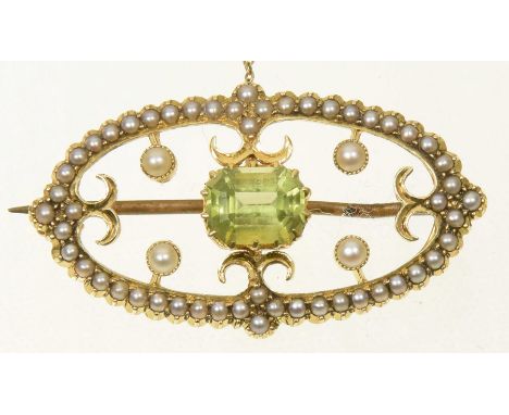 An early 20th Century peridot and split pearl broochThe rectangular shaped peridot within an oval shaped split pearl openwork