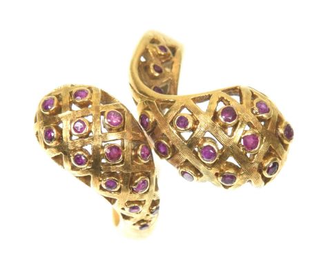 A Lalaounis ruby dress ringOf crossover design, the woven scrolling terminals with vari size circular shaped ruby accents to 