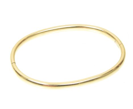 A 9ct gold diamond hinged bangleThe polished bangle inset with brilliant cut diamonds, to the plain reverse, estimated total 