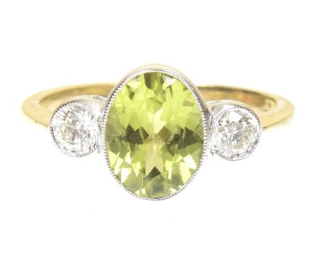 A peridot and diamond three stone ringThe oval shaped peridot with brilliant cut diamond collet sides, stamped 18ct, estimate