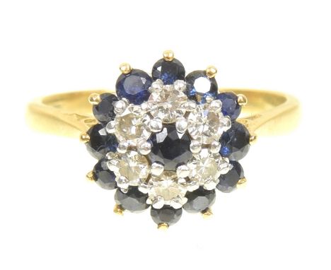 A sapphire and diamond cluster ringThe circular shape sapphire, within a brilliant cut diamond and circular shape sapphire do