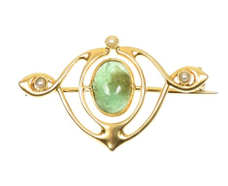 An early 20th Century Murrle Bennett & Co. 15ct gold emerald and split pearl broochThe oval emerald cabochon, within a scroll