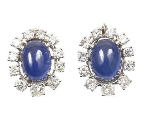 A pair of sapphire and diamond cluster earringsEach designed as an oval sapphire cabochon within a graduated vari cut diamond