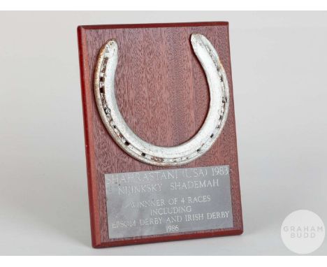 Shoe worn by the racehorse Shahrastani,mounted on a wooden plaque with easel support and set with an engraved metal plaque, 2