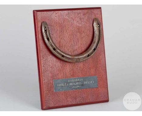 Shoe worn by the racehorse Darshaan,mounted on a wooden plaque with easel support and set with an engraved metal plaque, 20 b