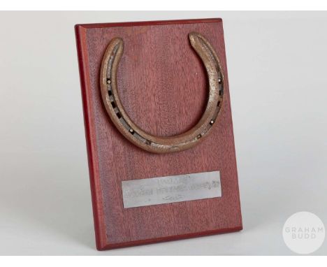 Shoe worn by the racehorse Daylami,mounted on a wooden plaque with easel support and set with an engraved metal plaque, 20 by