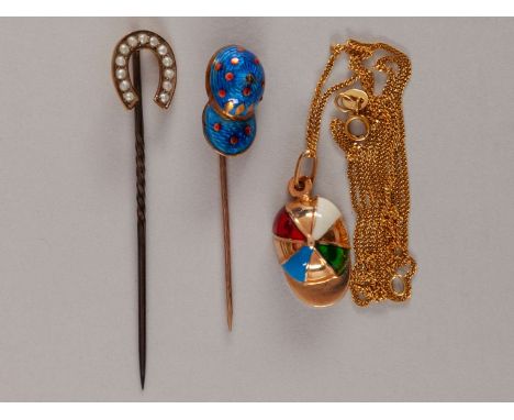 Three items of gold horse racing jewellery,a 9ct. gold & enamel jockey cap pendant with 9ct. gold chain; a 9ct. gold & blue e