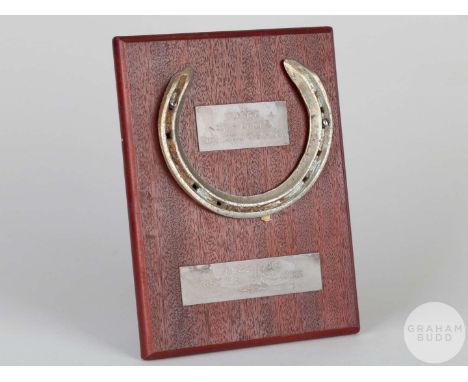 Shoe worn by the racehorse Niche,mounted on a wooden plaque with easel support and set with engraved metal plaques, 20 by 15c