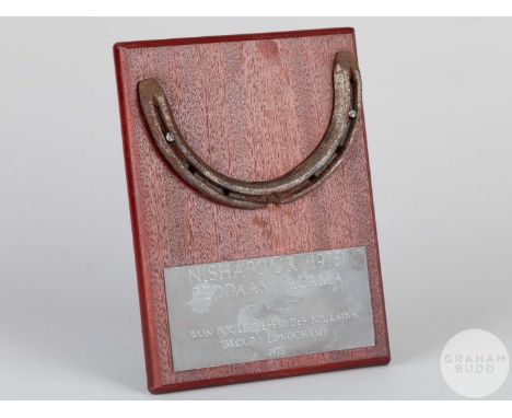 Shoe worn by the racehorse Nishapour,mounted on a wooden plaque with easel support and set with an engraved metal plaque, 20 
