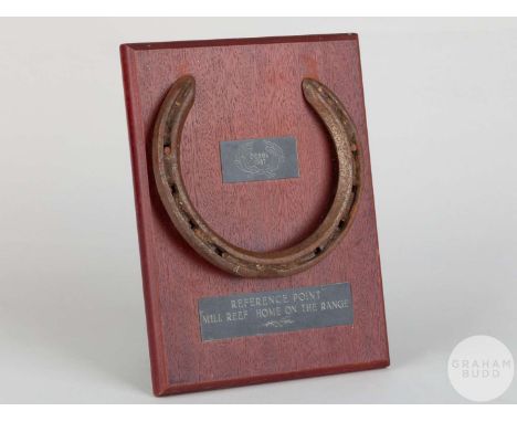 Shoe worn by the racehorse Reference Point, mounted on a wooden plaque with easel support and set with engraved metal plaques