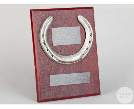 Shoe worn by the racehorse Carnegie when finishing third in the 1995 Breeders' Cup Turf at Belmont Park,mounted on a wooden p