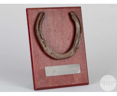 Shoe worn by the racehorse Zafonic,mounted on a wooden plaque with easel support and set with an engraved metal plaque, 20 by