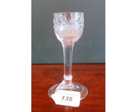 A 19th century cordial glass with etched bowl and clear glass stem on stepped conical base, 14cm tall.