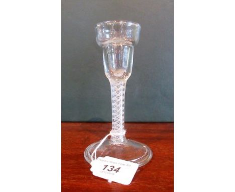 A 19th century cordial glass, having ring stepped bowl, ribbon and lattice corkscrew stem on stepped conical base, 15cm tall.