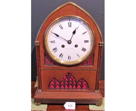 An early 20th century architectural oak mantle clock, with corinthian columns and lion mask handles on brass ball feet.