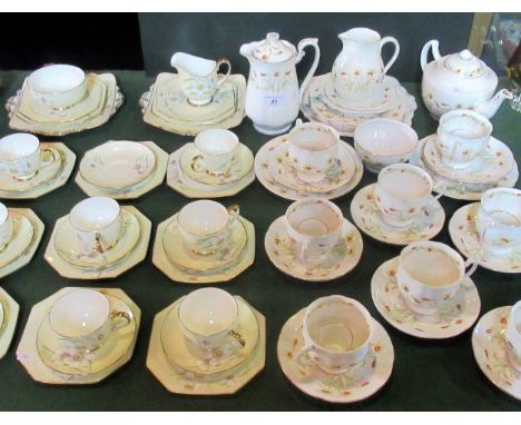 A Paragon part-tea service, comprising: eight trios, two cake plates, sugar bowl and milk jug, together with a standard china